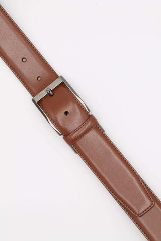 Tan leather belt buckle details.